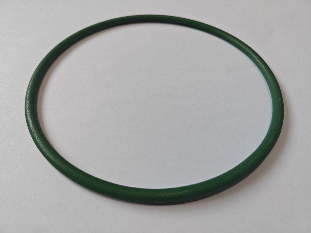 A green Movendis Molded PU Belt lies flat on a white surface, casting a subtle shadow.